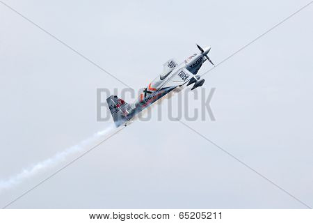 PUTRAJAYA, MALAYSIA - MAY 17, 2014: Hannes Arch from Austria in his Edge 540 V3 plane takes to the skies during the qualifying session of the Red Bull Air Race World Championship 2014.