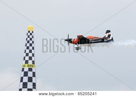 PUTRAJAYA, MALAYSIA - MAY 17, 2014: Nicolas Ivanoff from France in an Edge 540 V2 plane flies through the race course over Putrajaya lake at the Red Bull Air Race World Championship 2014.