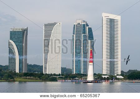 PUTRAJAYA, MALAYSIA - MAY 17, 2014: Hannes Arch from Austria in an Edge 540 V3 plane flies through the race course over Putrajaya lake at the Red Bull Air Race World Championship 2014.