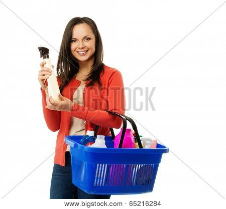Beautiful cheerful brunette woman with basket full and bottle of cleanser 