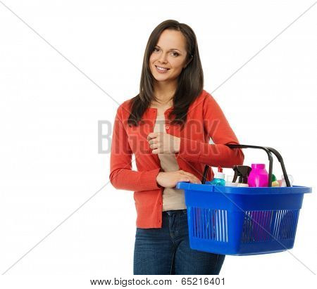 Beautiful cheerful brunette woman with basket full of cleansers 