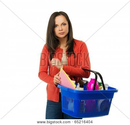 Beautiful cheerful brunette woman with basket full of cleansers 