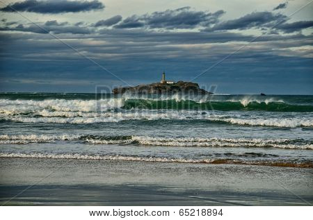 Spanish destination on Atlantic Ocean, Somo beach in Cantabria region, view on lighthouse