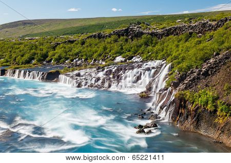 Hraunfossar is a very beautiful Icelandic waterfall in the west of the island. It comes from the lava field and pours into the Hvita river with a incredibly blue water. Long exposure.
