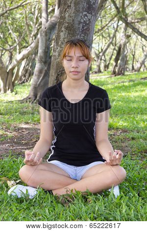 Young Women Sitting With Hunker Concentrated And Close The Eyes