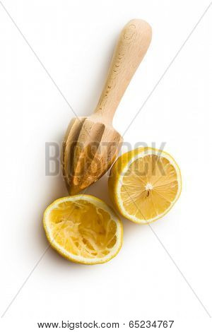 squeezed lemon fruit and citrus reamer on white background