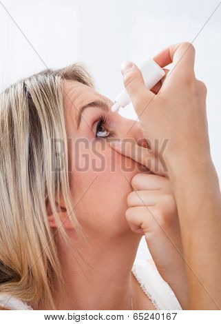 Woman Pouring Drops In Her Eyes