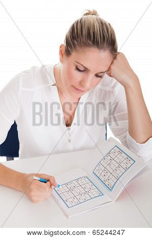 Young Woman Solving Sudoku