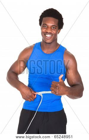 Bodybuilder With A Measuring Tape Around His Waist