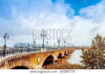 Old stony bridge in Bordeaux, France Europe