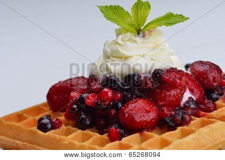 a selection of three italian gelato ice-cream scoops topped with nuts, chocolate, fruit served on crispy waffels