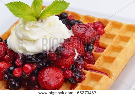 a selection of three italian gelato ice-cream scoops topped with nuts, chocolate, fruit served on crispy waffels