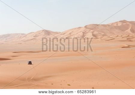 Car Among Sand Dunes In Oman Desert (oman)