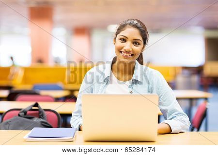 beautiful college girl using laptop in lecture hall