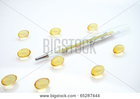 thermometer and yellow tablets