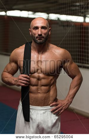 Sexy Muscular Man With Black Belt On Shoulder