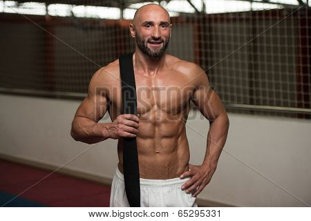 Sexy Muscular Man With Black Belt On Shoulder