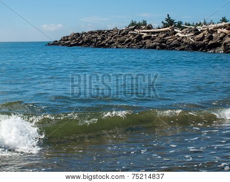 Gentle Beach Waves With A Rock Jetty
