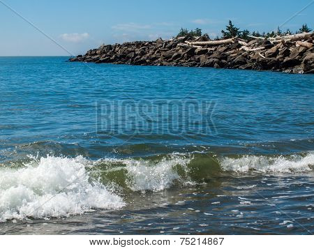 Gentle Beach Waves With A Rock Jetty