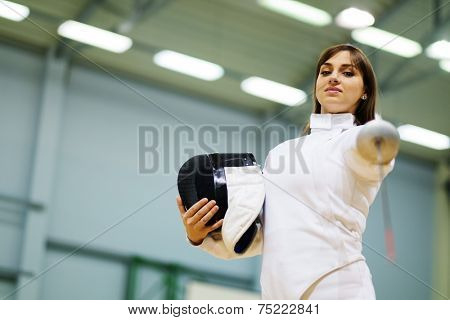 Young woman fencer with epee 