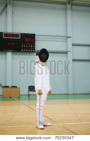 Little girl fencer with epee and mask