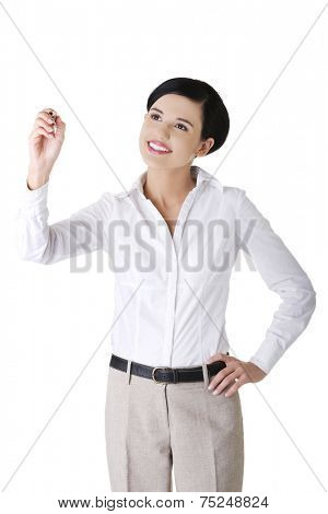 Happy businesswoman drawing on a glassboard