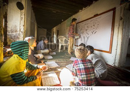 KATHMANDU, NEPAL - DEC 9, 2013: Unknown teacher and students in lesson at Jagadguru School. School established at 2013, to let new generation learn Sanskrit and preserve Hindu culture.