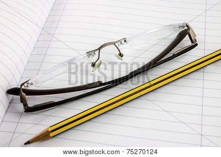 Notebook With Pencil And Glasses