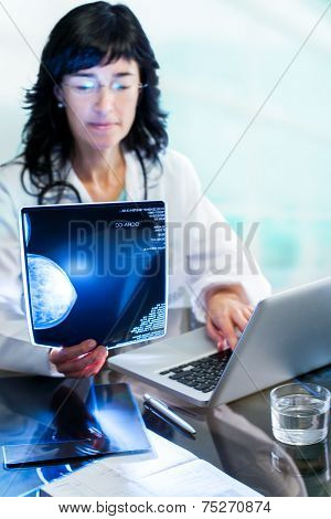 Female Doctor Analyzing  Mammogram X-ray.