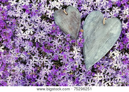 Greeting Card Two Wooden Hearts Atop A Lot Of Flowers