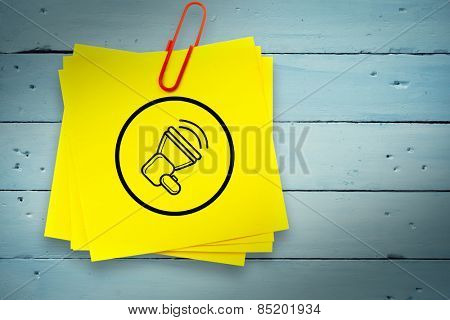 Megaphone graphic against sticky note with red paperclip