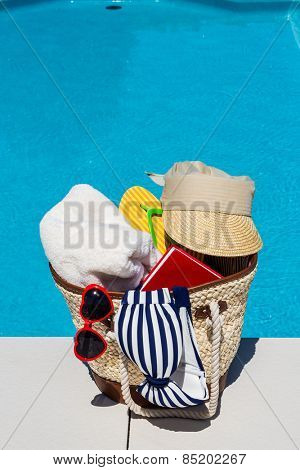 utensils for a nice relaxing vacation day lying next to a swimming pool. relaxation on vacation.