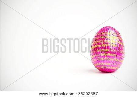 Happy easter in different languages against pink easter egg