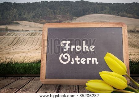 Yellow tulips against frohe ostern