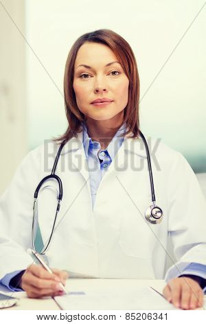 medicine and healthcare concept - busy doctor with laptop computer