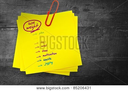 Diet plan against sticky note with red paperclip