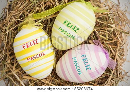 feliz pasqua against close up on three easter eggs
