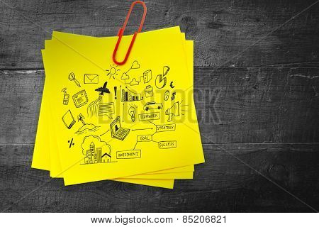 Brainstorm graphic against sticky note with red paperclip