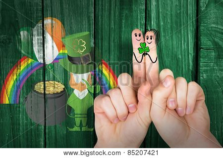 Patricks Day fingers against green wooden background