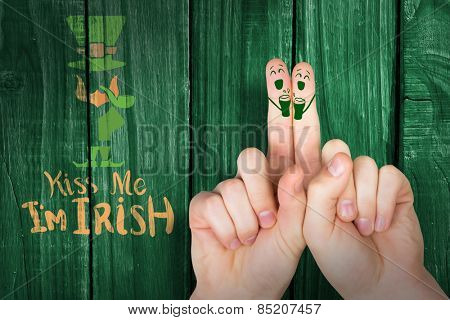 Patricks Day fingers against green wooden background