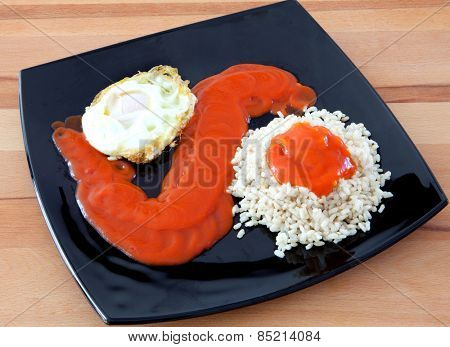 Fried egg with rice overcooked and tomato