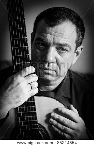 Man with a guitar. Black and white portrait