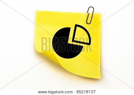 Pie chart against sticky note with grey paperclip