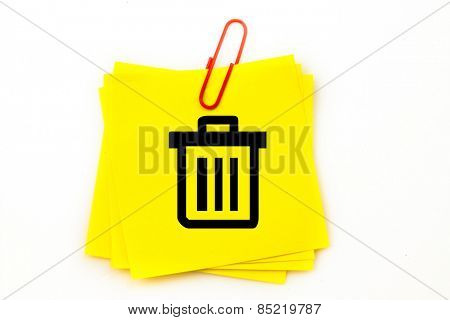 Trash can against sticky note with red paperclip