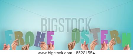Hands holding up frohe ostern against blue vignette background