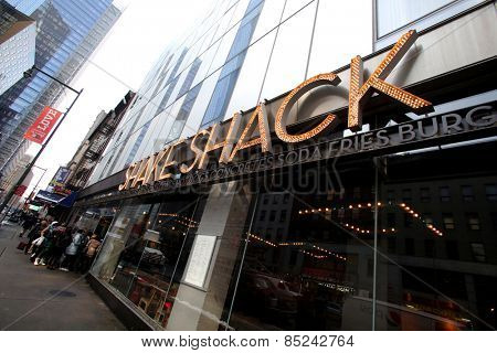 NEW YORK CITY - FEB. 25, 2015:  Pedestrians walk past a Shake Shack restaurant. Shake Shack is a fast casual restaurant chain based in New York City

