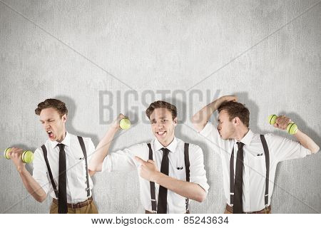 Nerd with dumbbell against white and grey background