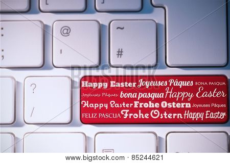 Happy easter in different languages against red key on keyboard