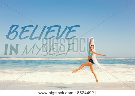 Fit woman jumping gracefully on the beach with scarf against believe in myself