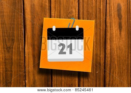 Calander against orange adhesive note with a paperclip